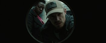 Movie still from “Suicide Squad” (2016), directed by David Ayer – A man and a woman looking into a round mirror; Close Up shot, Low angle