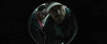 Movie still from “Suicide Squad” (2016), directed by David Ayer – A man and a woman looking into a round mirror; Close Up shot, Low angle