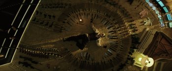 Movie still from “Suicide Squad” (2016), directed by David Ayer – A man is laying on the ground in the middle of a circle of knives; Wide shot, Overhead angle