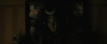 Movie still from “Suicide Squad” (2016), directed by David Ayer – A woman with a crescent moon on her head; Close Up shot, High angle