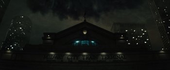 Movie still from “Suicide Squad” (2016), directed by David Ayer – A train station at night lit up by street lights; Extreme Wide shot, Low angle