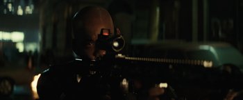 Movie still from “Suicide Squad” (2016), directed by David Ayer – A man with a gun in a dark room; Close Up shot, Low angle
