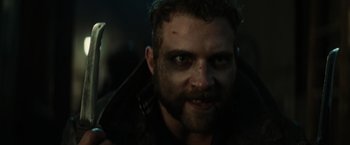 Movie still from “Suicide Squad” (2016), directed by David Ayer – A person with a beard; Close Up shot, Over the shoulder angle