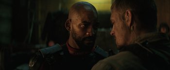 Movie still from “Suicide Squad” (2016), directed by David Ayer – A man with a bald head is looking at another man with a beard; Close Up shot, Over the shoulder angle