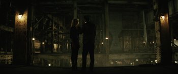 Movie still from “Suicide Squad” (2016), directed by David Ayer – A man and a woman standing next to each other; Wide shot, Over the shoulder angle