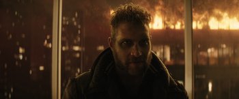 Movie still from “Suicide Squad” (2016), directed by David Ayer – A person wearing a jacket; Close Up shot, Over the shoulder angle