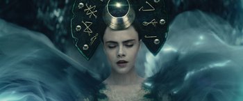 Movie still from “Suicide Squad” (2016), directed by David Ayer – A woman wearing a crown with symbols on her head; Close Up shot, Overhead angle