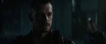 Movie still from “Suicide Squad” (2016), directed by David Ayer – A person wearing a jacket; Close Up shot, Over the shoulder angle