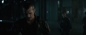 Movie still from “Suicide Squad” (2016), directed by David Ayer – A person with a gun; Close Up shot, Over the shoulder angle