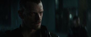 Movie still from “Suicide Squad” (2016), directed by David Ayer – A person with wet hair; Close Up shot, Over the shoulder angle