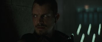 Movie still from “Suicide Squad” (2016), directed by David Ayer – A person looking at the camera; Close Up shot, Low angle