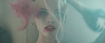 Movie still from “Suicide Squad” (2016), directed by David Ayer – A person with a piercing on her face; Close Up shot, Overhead angle