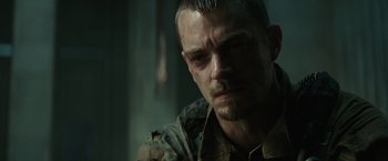 Movie still from “Suicide Squad” (2016), directed by David Ayer – A person wearing a shirt; Close Up shot, Over the shoulder angle