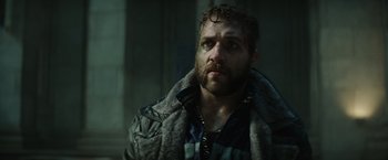 Movie still from “Suicide Squad” (2016), directed by David Ayer – A person wearing a jacket; Close Up shot, Low angle