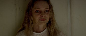 Movie still from “Suitable Flesh” (2023), directed by Joe Lynch – A person with long blonde hair; Close Up shot, Low angle