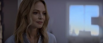 Movie still from “Suitable Flesh” (2023), directed by Joe Lynch – A woman with long blonde hair wearing a white shirt; Close Up shot, Over the shoulder angle