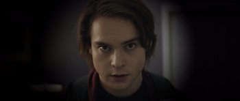 Movie still from “Suitable Flesh” (2023), directed by Joe Lynch – A person with long hair; Close Up shot, Low angle