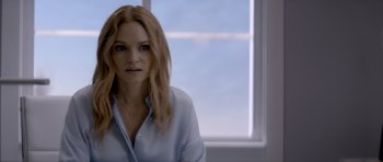 Movie still from “Suitable Flesh” (2023), directed by Joe Lynch – A woman with long blonde hair wearing a white shirt; Close Up shot, Over the shoulder angle