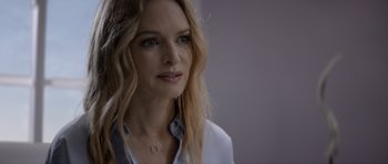 Movie still from “Suitable Flesh” (2023), directed by Joe Lynch – A person with long blonde hair; Close Up shot, Over the shoulder angle