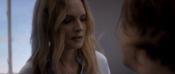 Movie still from “Suitable Flesh” (2023), directed by Joe Lynch – A person talking to another person; Close Up shot, Over the shoulder angle