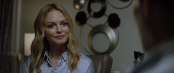 Movie still from “Suitable Flesh” (2023), directed by Joe Lynch – A woman sitting in a chair in front of a mirror; Close Up shot, Over the shoulder angle