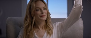 Movie still from “Suitable Flesh” (2023), directed by Joe Lynch – A person with long blonde hair; Close Up shot, Over the shoulder angle