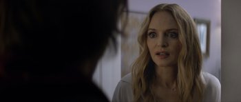 Movie still from “Suitable Flesh” (2023), directed by Joe Lynch – A person looking at a mirror; Close Up shot, Over the shoulder angle