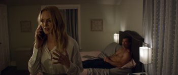 Movie still from “Suitable Flesh” (2023), directed by Joe Lynch – A man and a woman in a bedroom; Medium shot, Over the shoulder angle