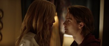 Movie still from “Suitable Flesh” (2023), directed by Joe Lynch – A man and a woman face to face in the dark; Close Up shot, Low angle