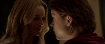 Movie still from “Suitable Flesh” (2023), directed by Joe Lynch – A woman and a man face to face in a dark room; Close Up shot, Over the shoulder angle