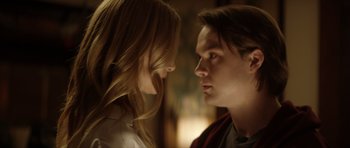 Movie still from “Suitable Flesh” (2023), directed by Joe Lynch – A man and a woman face to face in a dark room; Close Up shot, Over the shoulder angle