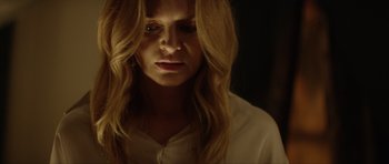 Movie still from “Suitable Flesh” (2023), directed by Joe Lynch – A woman with long blonde hair and a white shirt; Close Up shot, Low angle