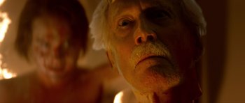 Movie still from “Suitable Flesh” (2023), directed by Joe Lynch – An old man with a white beard and mustache; Extreme Close Up shot, Low angle