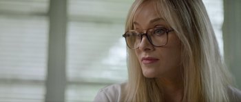 Movie still from “Suitable Flesh” (2023), directed by Joe Lynch – A person wearing glasses and a white shirt; Close Up shot, Over the shoulder angle