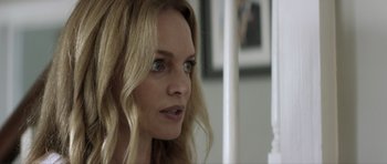 Movie still from “Suitable Flesh” (2023), directed by Joe Lynch – A person with blonde hair; Close Up shot, Over the shoulder angle