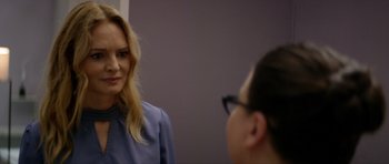 Movie still from “Suitable Flesh” (2023), directed by Joe Lynch – A woman in a blue shirt is talking to another woman in glasses; Close Up shot, Over the shoulder angle