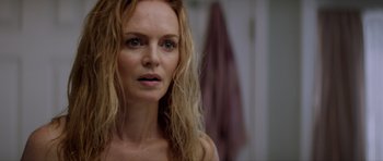 Movie still from “Suitable Flesh” (2023), directed by Joe Lynch – A person with long blonde hair; Close Up shot, Over the shoulder angle