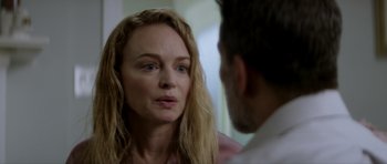 Movie still from “Suitable Flesh” (2023), directed by Joe Lynch – A man and a woman looking at one another in a room; Close Up shot, Over the shoulder angle