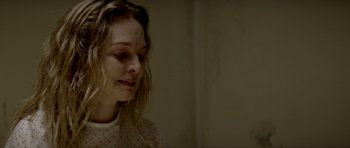 Movie still from “Suitable Flesh” (2023), directed by Joe Lynch – A person wearing a white and red polka dot shirt; Close Up shot, Over the shoulder angle