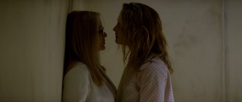 Movie still from “Suitable Flesh” (2023), directed by Joe Lynch – Two young women standing next to each other face to face; Close Up shot, Low angle