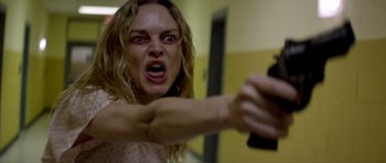 Movie still from “Suitable Flesh” (2023), directed by Joe Lynch – A woman with her mouth wide open and her fist in the air; Close Up shot, Low angle