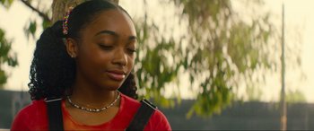 Movie still from “Summering” (2022), directed by James Ponsoldt – A young woman with her eyes closed in front of a tree; Close Up shot, Over the shoulder angle