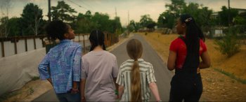 Movie still from “Summering” (2022), directed by James Ponsoldt – A group of people walking down a street; Medium shot, Low angle