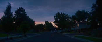 Movie still from “Summering” (2022), directed by James Ponsoldt – A person standing in the middle of a street at night; Extreme Wide shot, Low angle