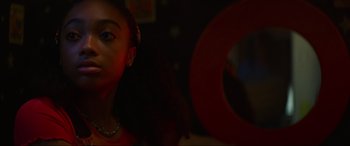 Movie still from “Summering” (2022), directed by James Ponsoldt – A young girl is standing in front of a target sign; Close Up shot, Low angle