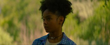 Movie still from “Summering” (2022), directed by James Ponsoldt – A young woman with an afro wearing a blue jacket; Close Up shot, Low angle