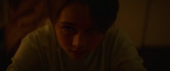 Movie still from “Summering” (2022), directed by James Ponsoldt – A young woman is looking into the camera; Extreme Close Up shot, Low angle
