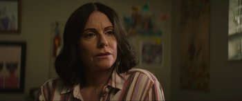 Movie still from “Summering” (2022), directed by James Ponsoldt – A person wearing a striped shirt; Close Up shot, Over the shoulder angle