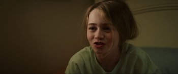Movie still from “Summering” (2022), directed by James Ponsoldt – A young woman with a green shirt is smiling; Close Up shot, Over the shoulder angle