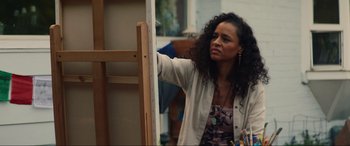 Movie still from “Summering” (2022), directed by James Ponsoldt – A woman standing in front of an easel in a room; Close Up shot, Over the shoulder angle